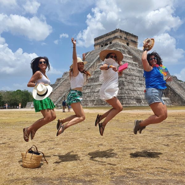 Viajantes explorando o sítio arqueológico de Chichén Itzá com a Exploratours